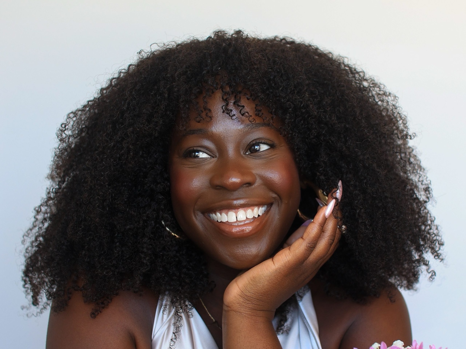 Smiling Black woman representing joy, inclusivity, and wellness